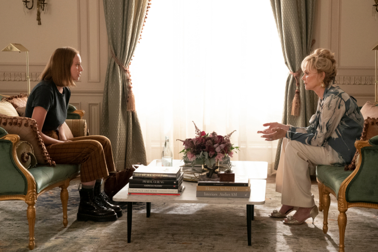 Deborah and Ava sitting on opposite side of a living room having a tense conversation.