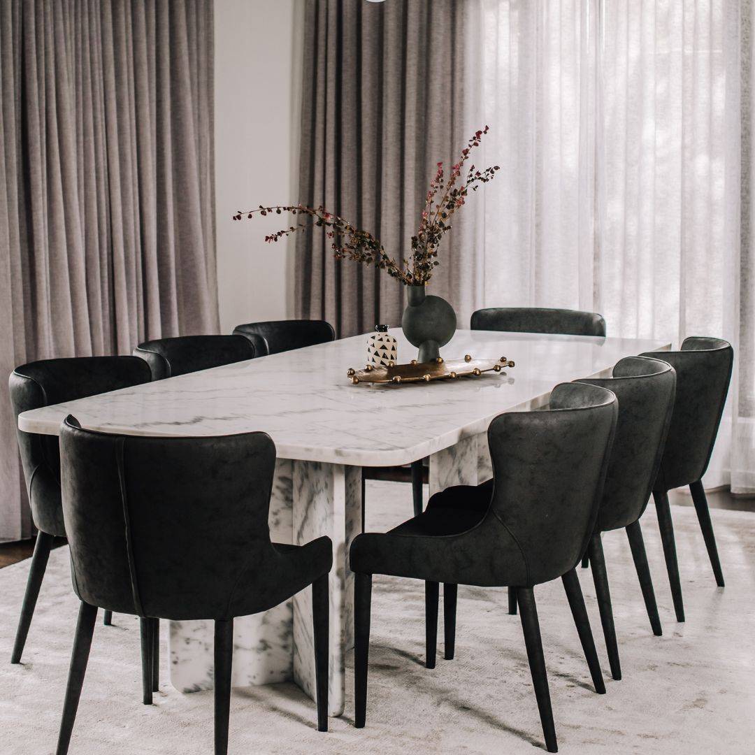 dining room set with two vases, marble table, and black chairs