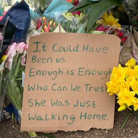 Flowers and placard for Sarah Everard at Clapham Common bandstand