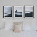 black and white photography prints above bed 