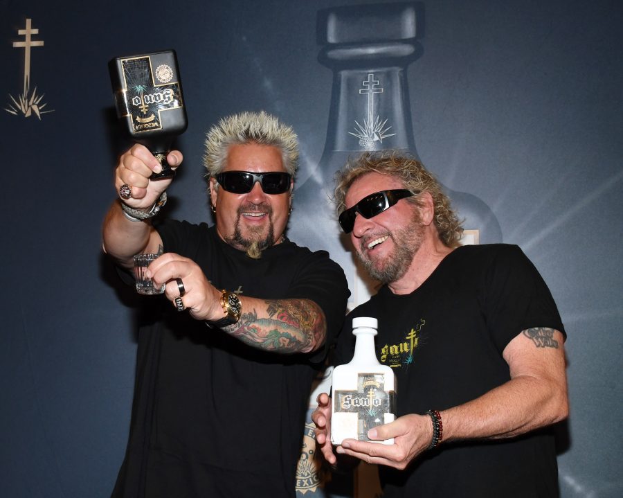 Guy-Fieri-and-Sammy-Hagar-Laughing-While-Posing-with-Bottles-of-Santo-Puro-Mezquila-and-new-Santo-Fino-Blanco-at-Southern-Wine-Spirits-in-Las-Vegas-horizontal-900x719.jpg