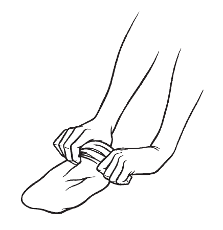 Hands putting rolled up stocking on foot
