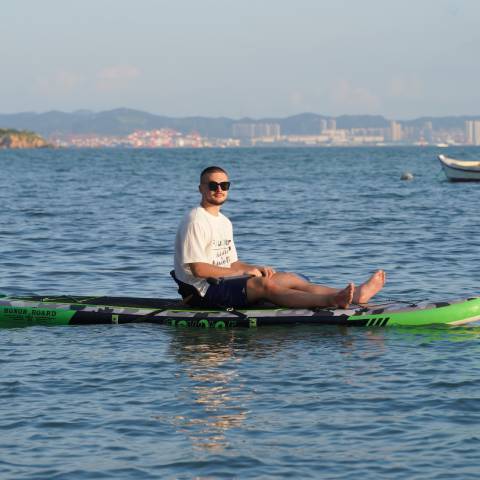 Boy inflatable paddleboarding in Toronto