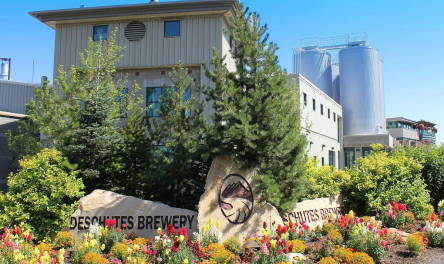 outside Bend Tasting Room and Beer Garden, there are trees and flowers in front