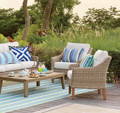 outdoor rattan furniture with colorful pillows and rug