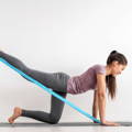 Young 30 year old female Stretching elastic band in yoga move.