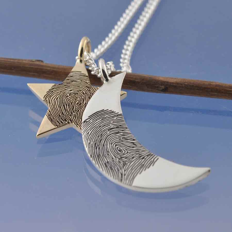 fingeprint necklace featuring a silver crescent moon and a 9k gold star