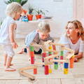 Family playing with Montessori Wooden Marble Run set. 