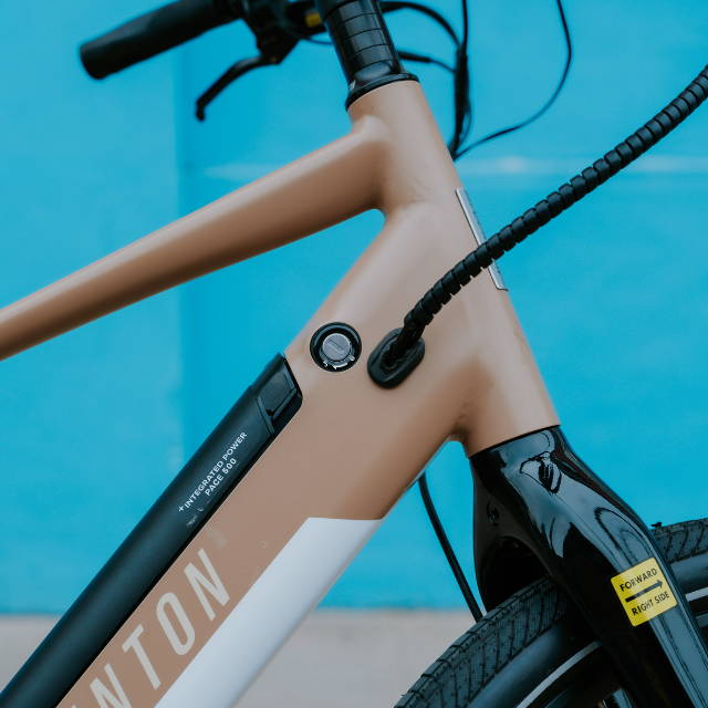 Woman in yellow jacket with electric bike
