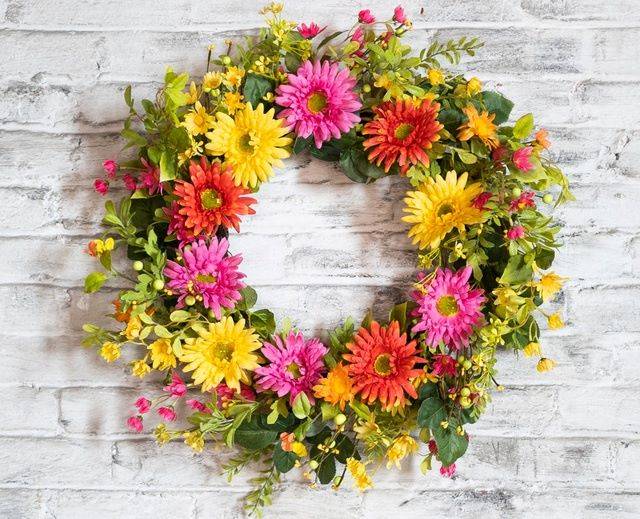artificial wreath and bright gerbera daisies