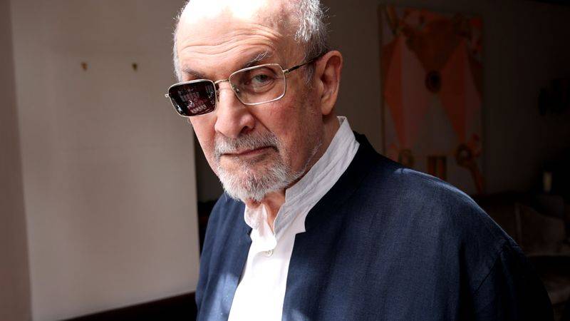 Image may contain: Salman Rushdie, Face, Head, Person, Photography, Portrait, Adult, Accessories, Glasses, Clothing, and Coat