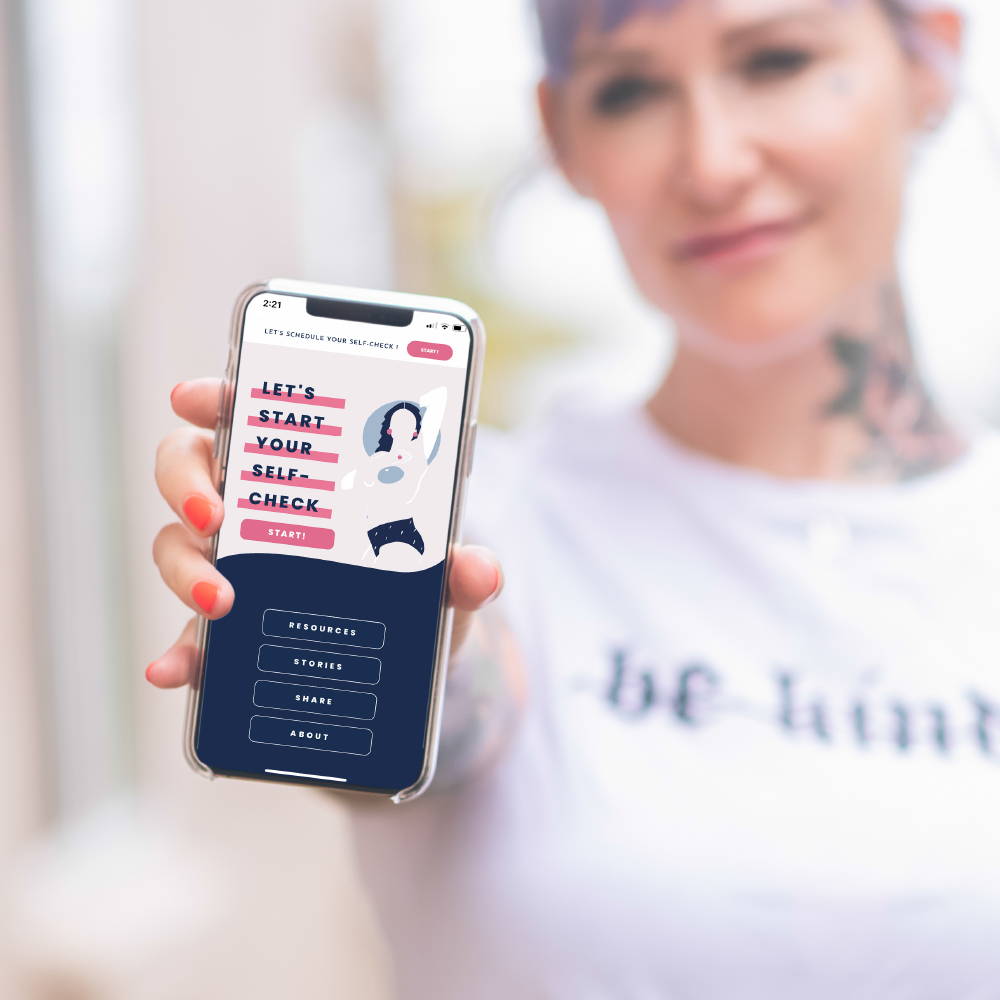 A women showing her mobile app on her phone for the New Keep a Breast App