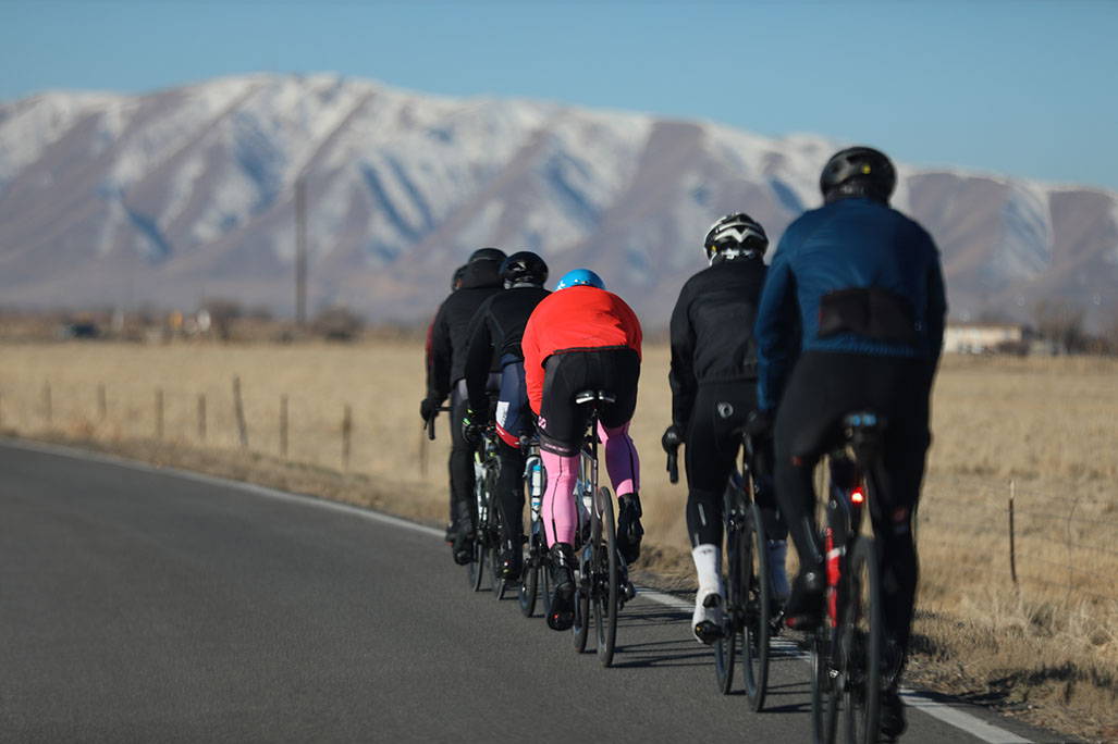 small group biking towards mountainscape