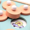 Close-up of a Montessori Memory Game showing a cartoon car uncovered. 