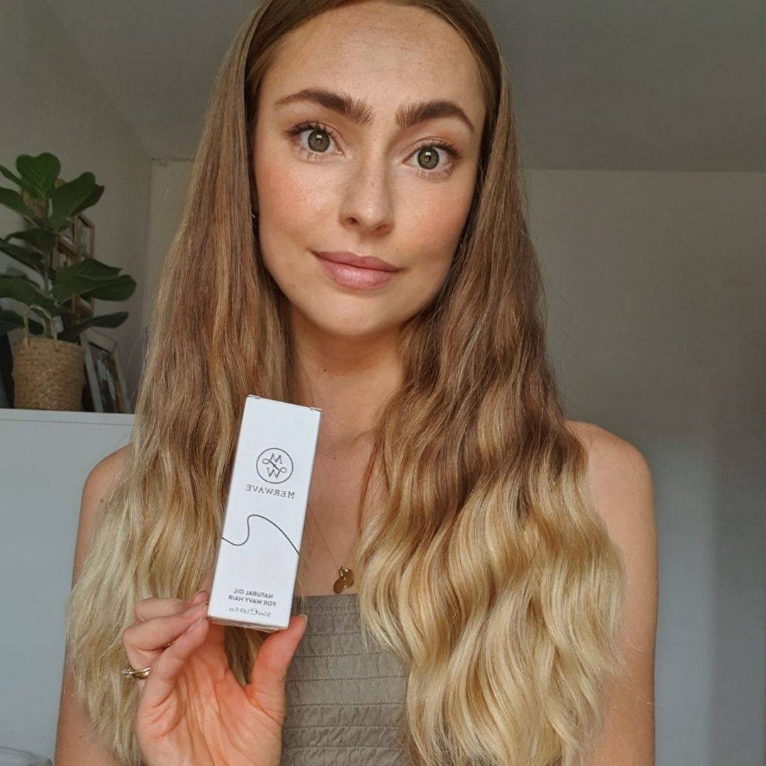 Photo of women holding wavy hair oil