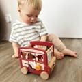 Kid opening a top piece from the Smart Safari Bus toy to take wooden animals out. 