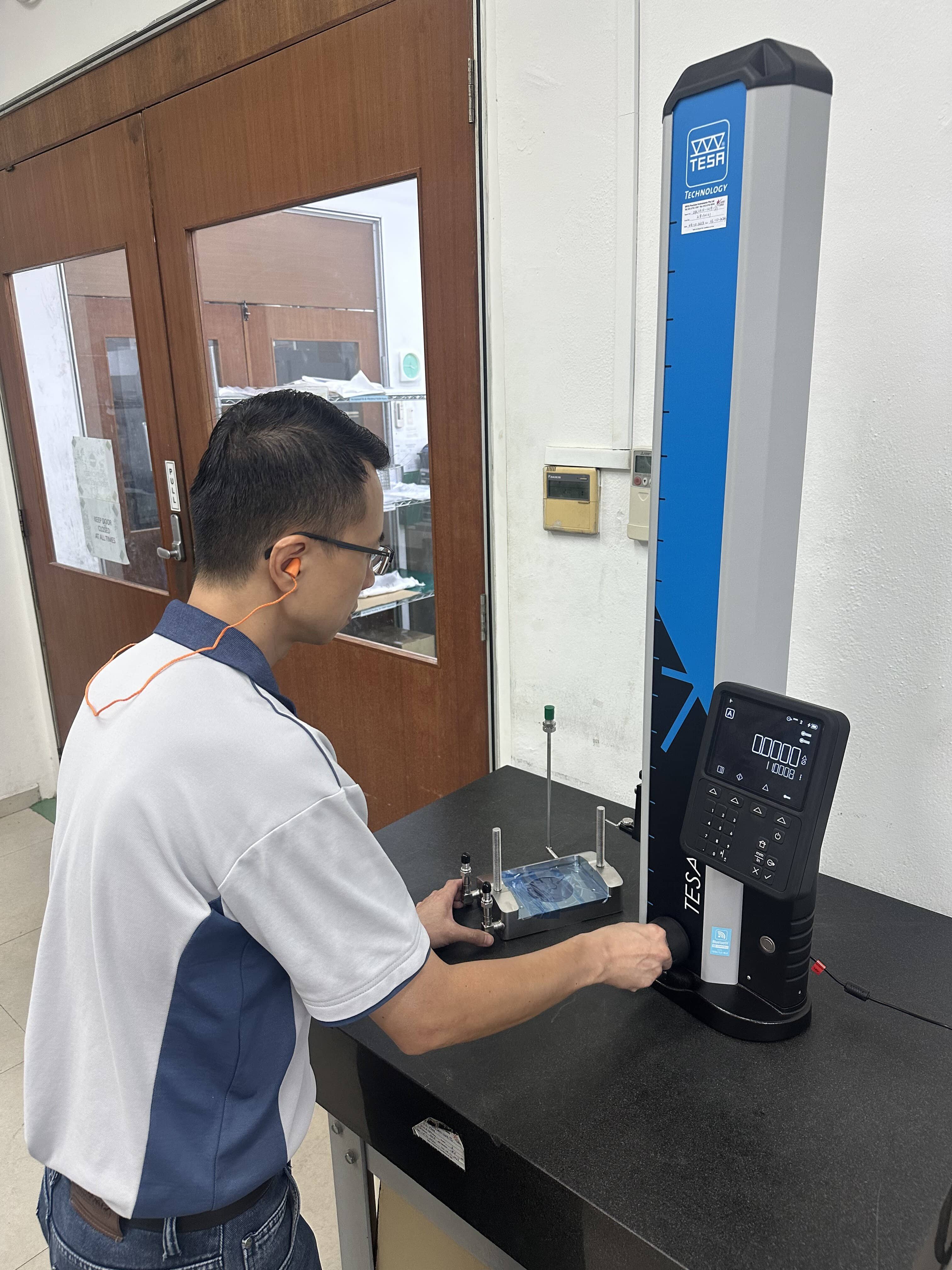 QC operator using a CMM machine to inspect a part