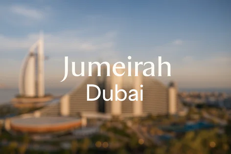 Blurred Dubai skyline view featuring the iconic Burj Al Arab and Jumeirah Beach Hotel against a clear sky.
