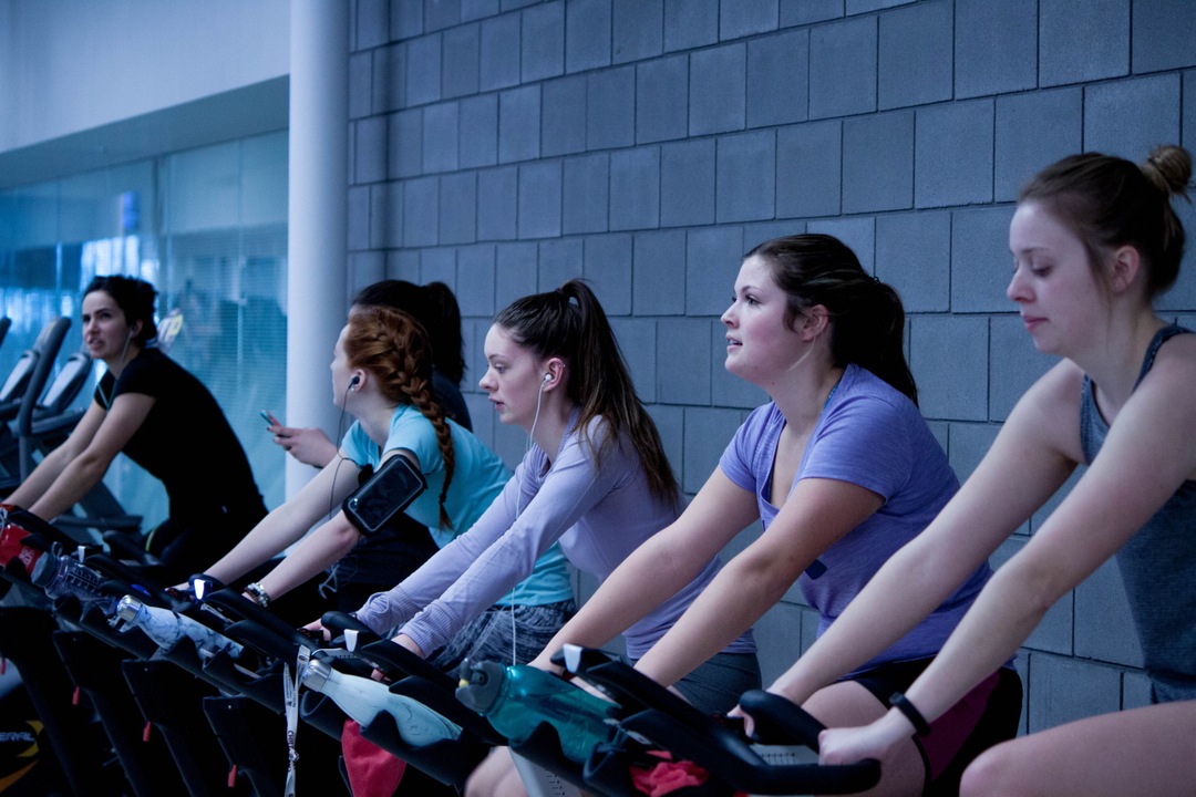 Women on exercise bikes in the gym