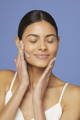 woman applying hydrating face mask on her skin