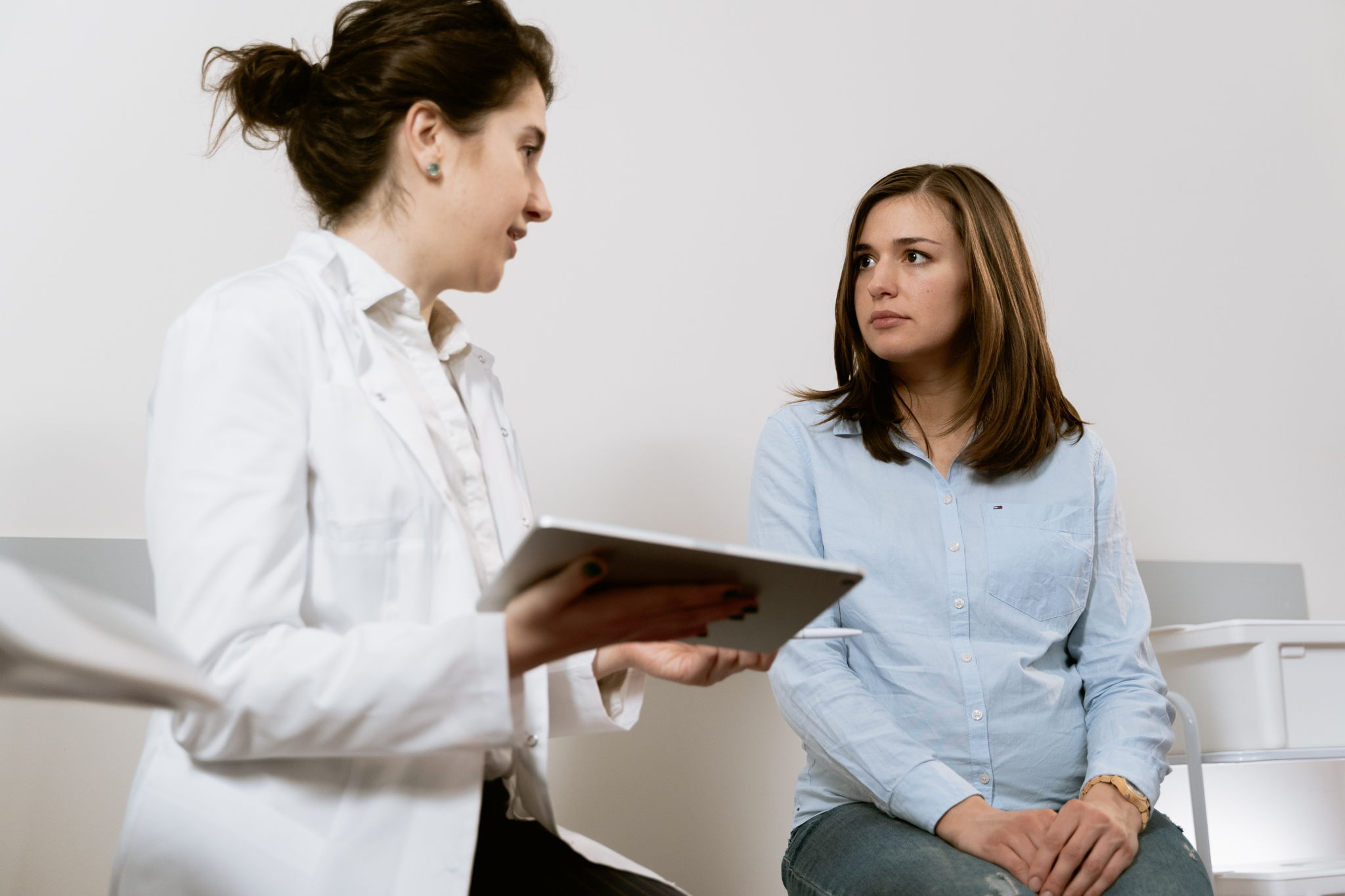 woman doctor patient consult consultation visit