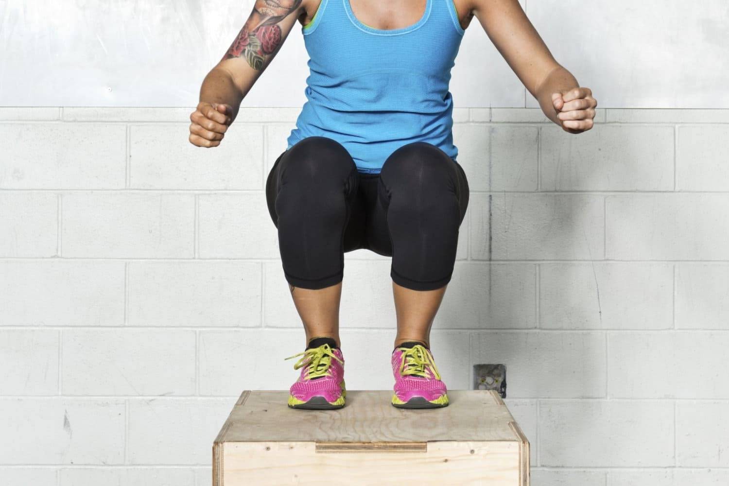 female athlete doing plyo box workout