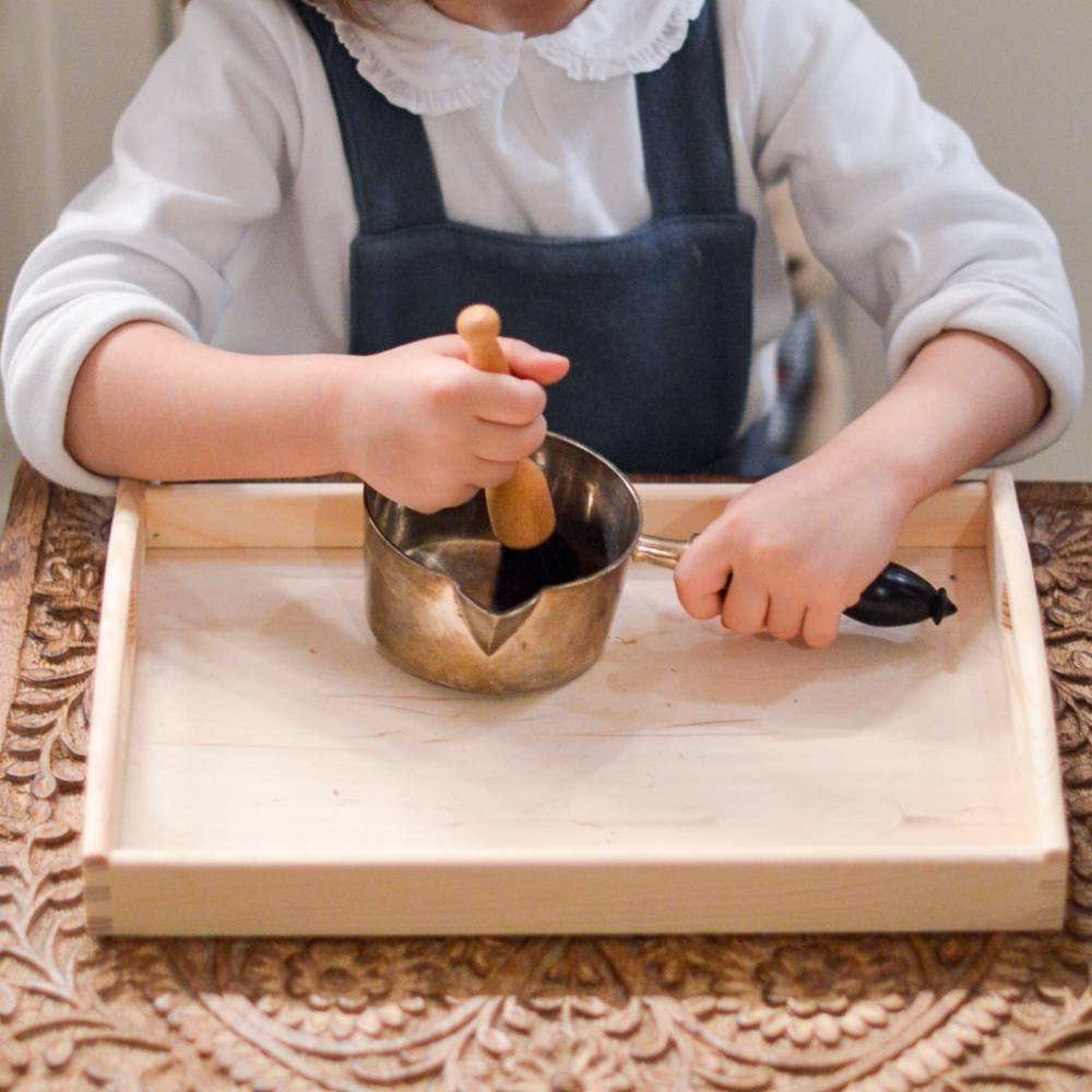 Un petit garçon utilise des couverts enfant pour dresser le couvert