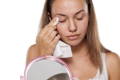 woman removing her makeup with a single use wet wipe which is bad for her skin and the environment 