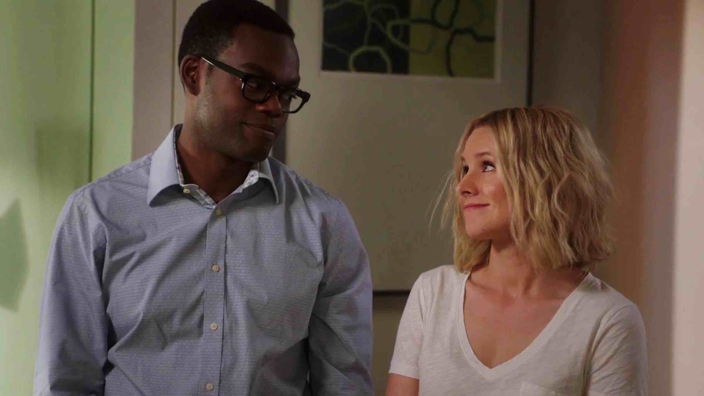 Eleanor and Chidi, characters from The Good Place, looking at each-other with tender and a soft smile.