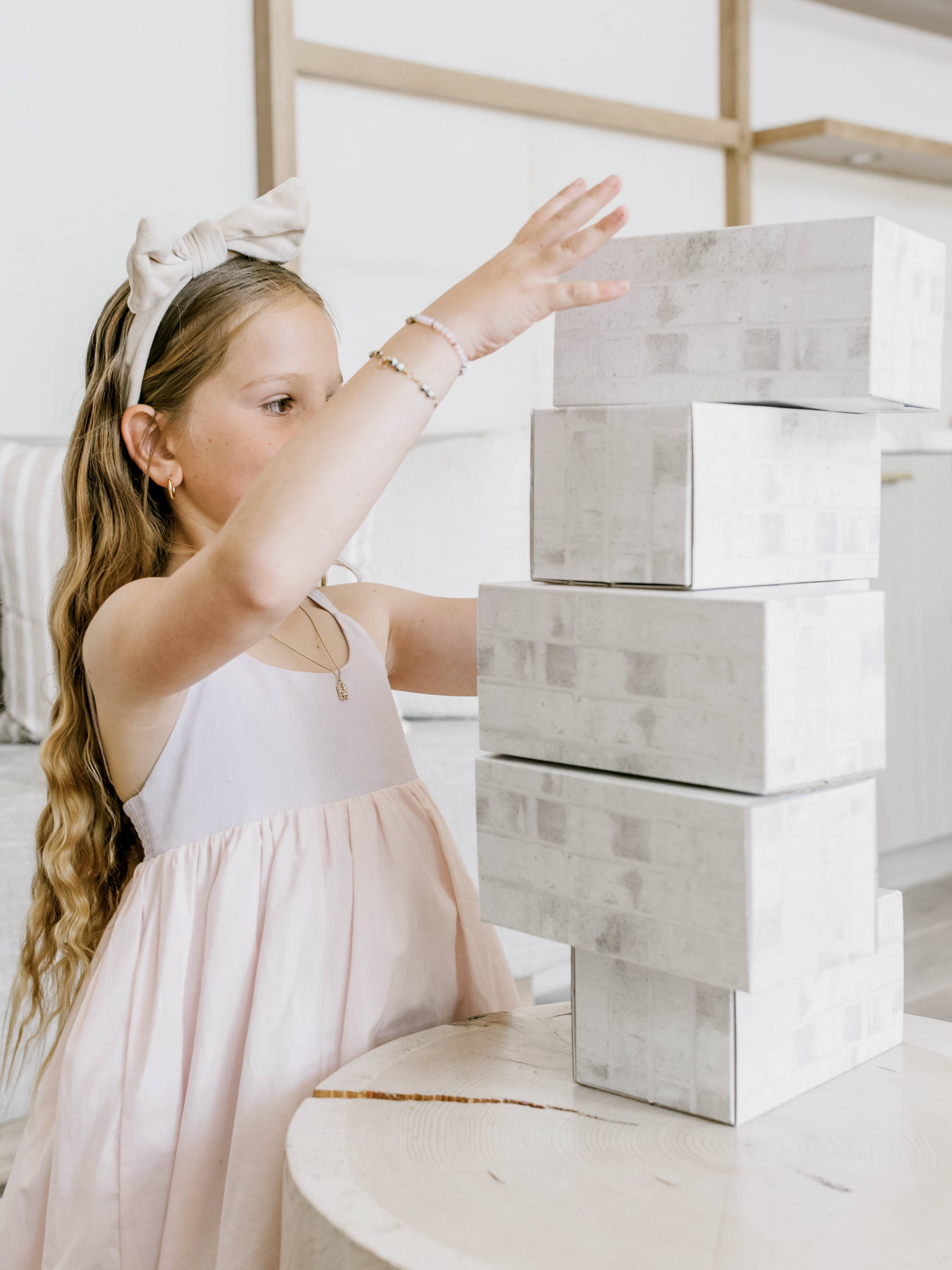 Girl stacking white building blocks