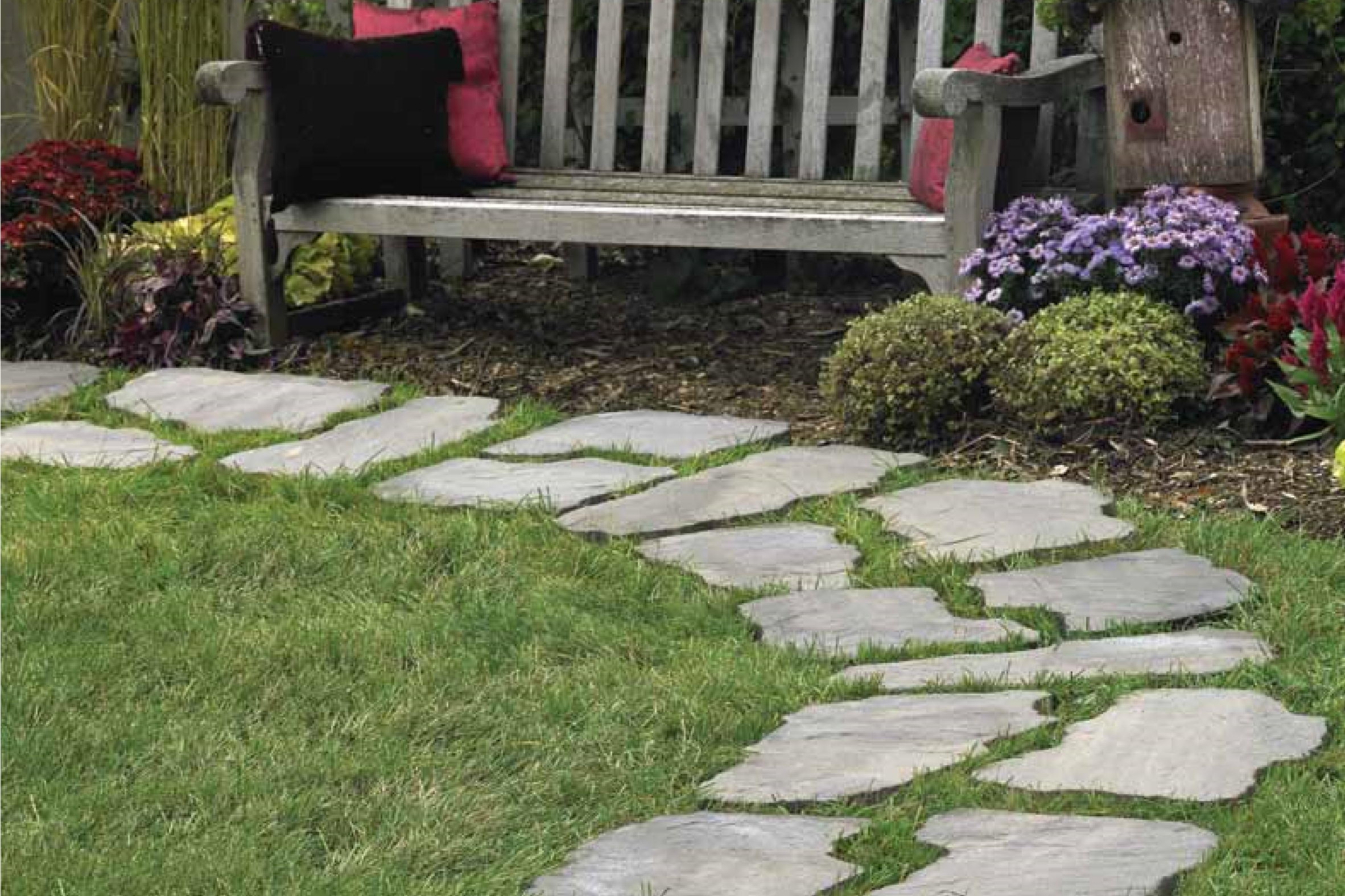 Walkway made with Footnotes Stepping Stones with a bench and flowers.