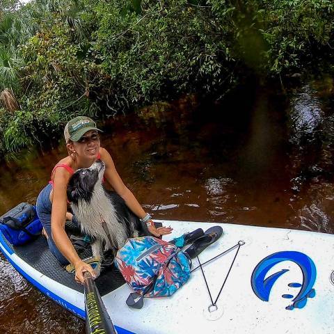 Girl stand up paddleboarding with her dog on Funwater inflatable stand up paddle board