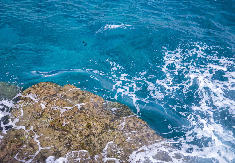 Hawaiian water crashes against the rocks