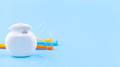 Photo of dental floss and interdental brush angles on blue
