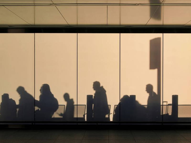 Image may contain: Adult, Person, Silhouette, Airport, Terminal, People, and Indoors