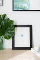 blue dog nose print in black frame on decorated table