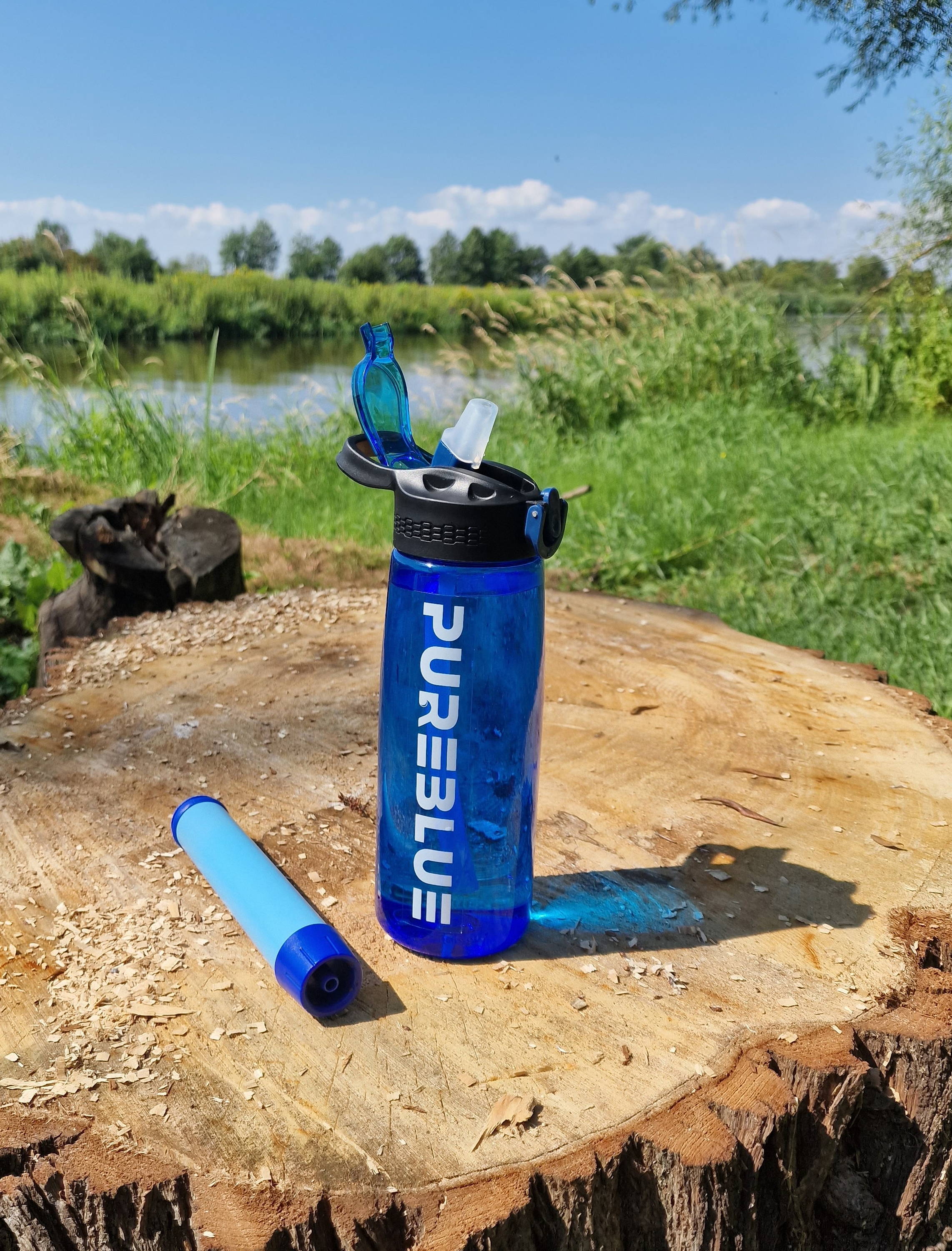 water bottle with filter on a treestump