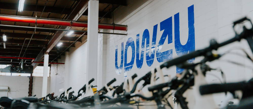 Upway UpCenter logo and electric bikes