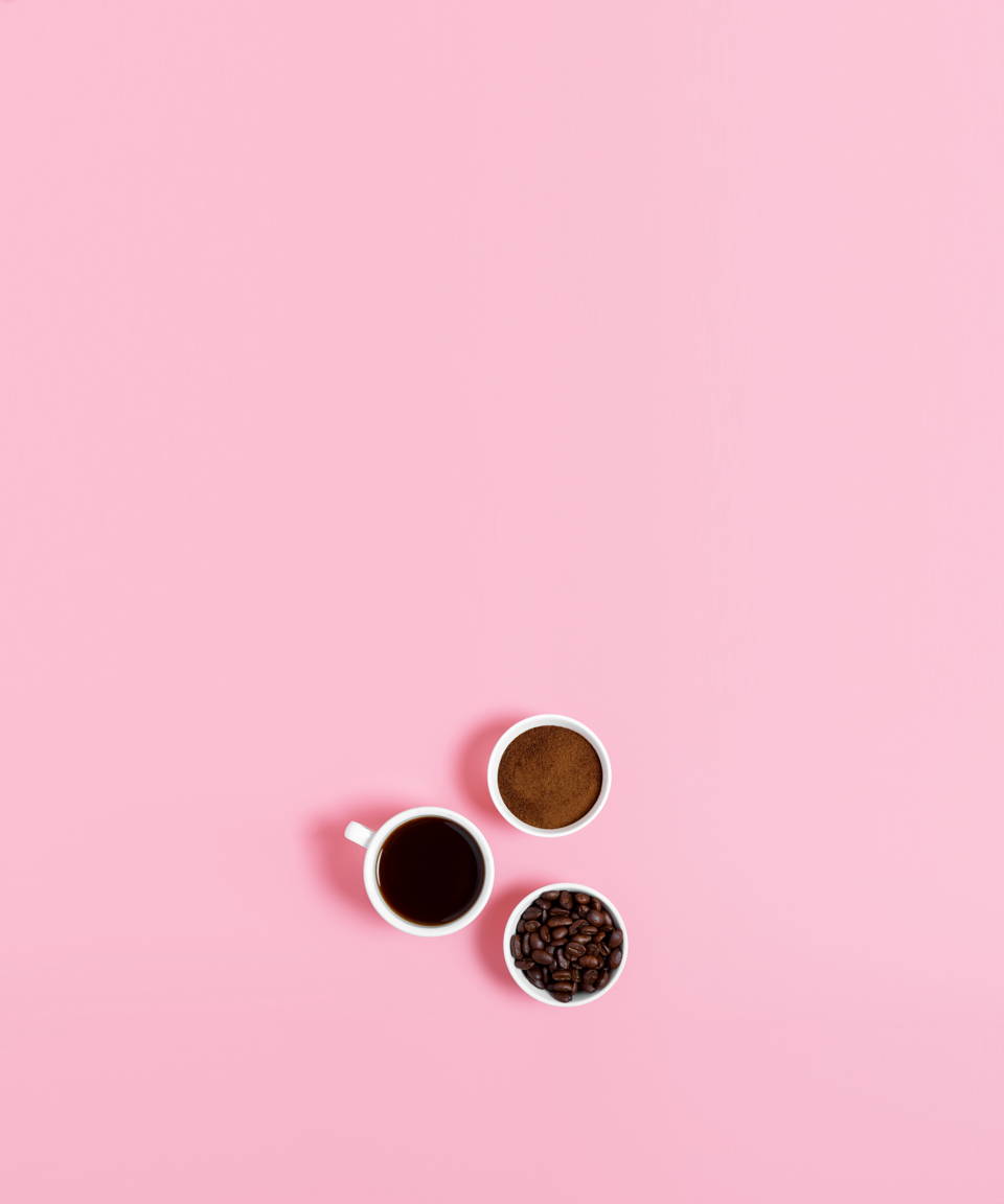 A birds eye view of two cups of coffee and a bowl of coffee beans for Confetti's Virtual Coffee Tasting