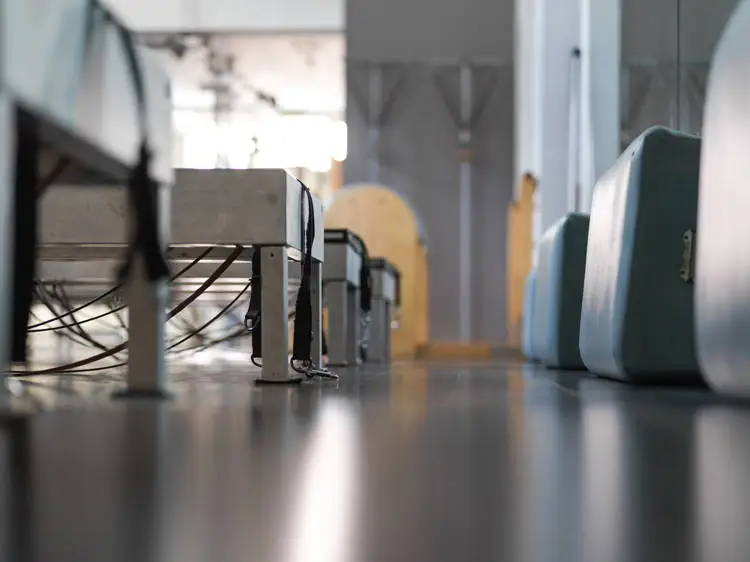 Series of Pilates reformers and Reformer boxes, ladder barrel and pedi poles in the background