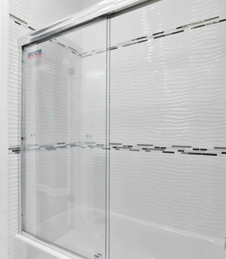bathroom featuring hardwood floors, natural light, and shower / bath combination with glass door