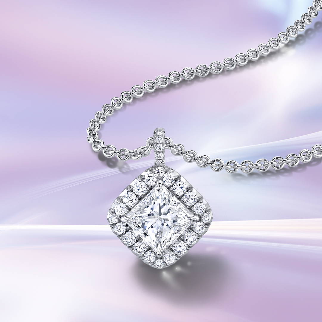 Princess cut diamond pendant with diamond halo on a purple background