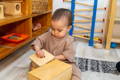 Little girl playing with wooden toy. 