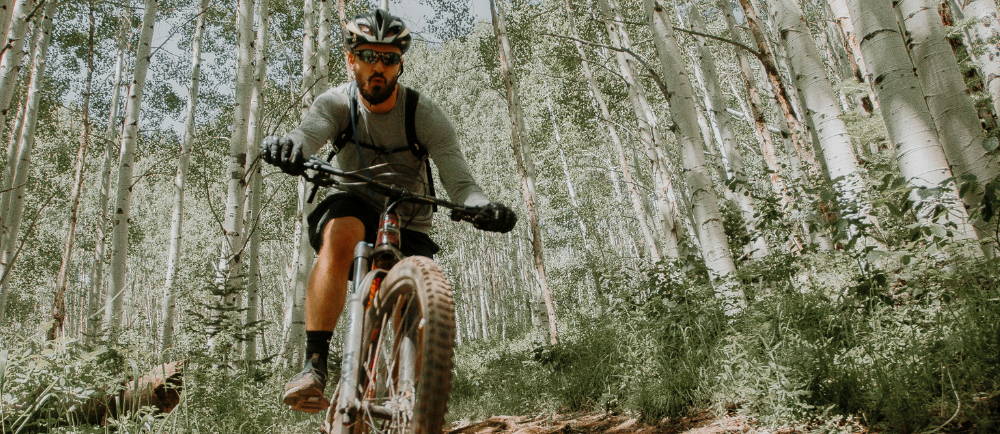 A man riding an electric mountain bike in the cottonwoods