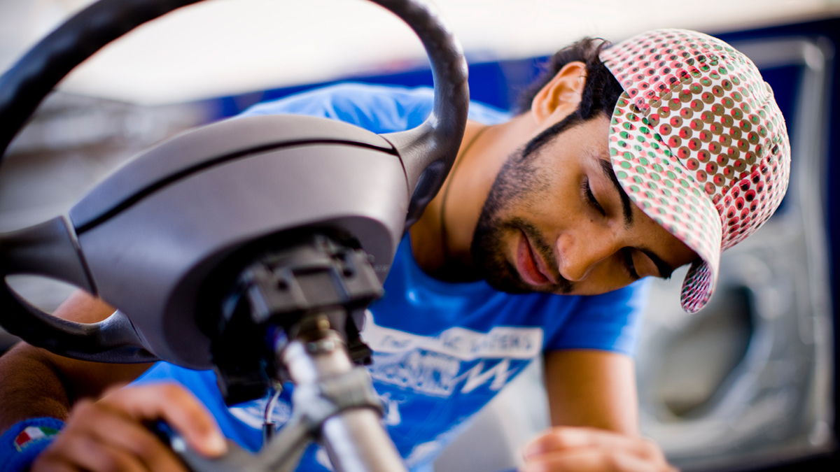 An engineering student checking on a steering wheel