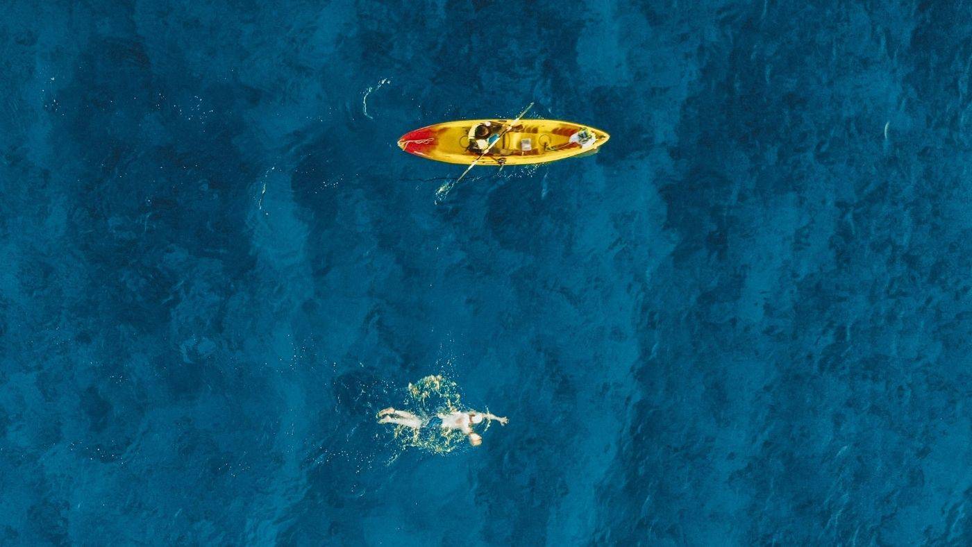 Jon Schutte Photography Oliver Rush Swims around Grand Cayman Kayak with swimmer in Ocean