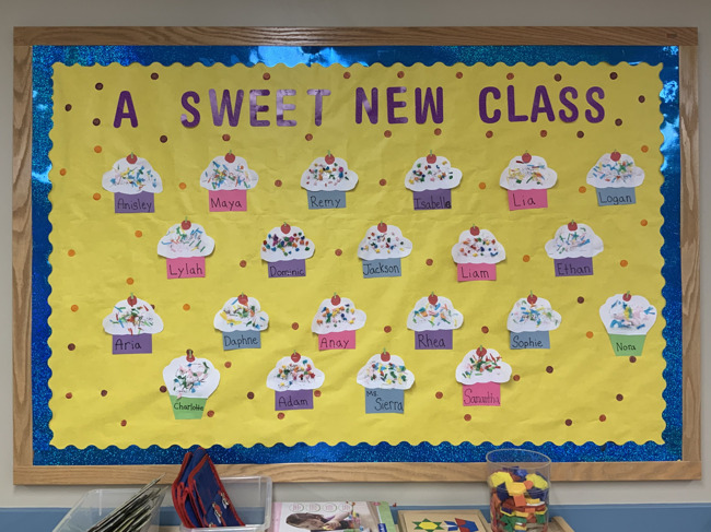 Bulletin board with cupcakes and the names of all our new children in the opening of our Preschool 2 classroom at Primrose 