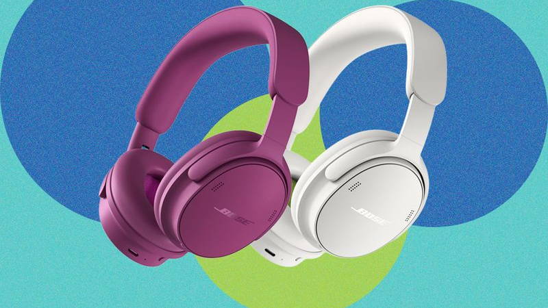 Two padded over-the-ear headphones, one in purple and the other in white