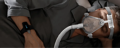 Person using CPAP mask with Checkme O2 Max wrist oxygen monitor to track oxygen during sleep therapy