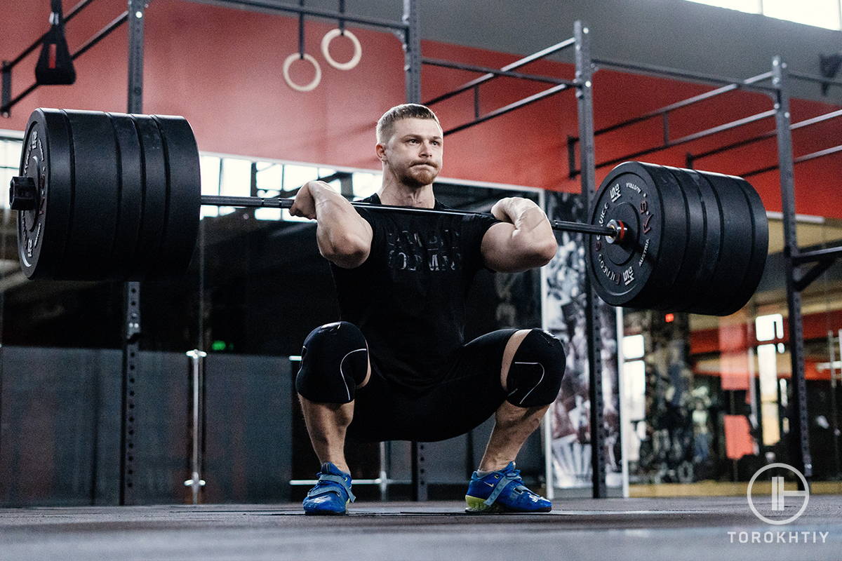 WBCM the man performing squat with heavy bar WBCM the man performing squat with heavy bar
